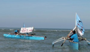 NOT ON OUR WATERS. Participants from Timek-La Union banner their calls for the rights and benefits for the fisherfolk onto their fishing boats and paraded them on the coasts on Agoo, La Union. Photo by Nathan Salvador